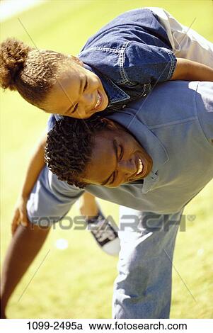 people, balance, playing, excitement, riding, playful, back View Large Photo Image Stock Image - people, balance, playing, excitement, riding, playful, back. Fotosearch