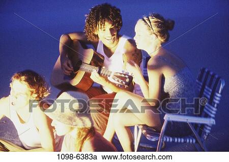 Stock Image - people, beach, guitar, camping, friends, teens. Fotosearch