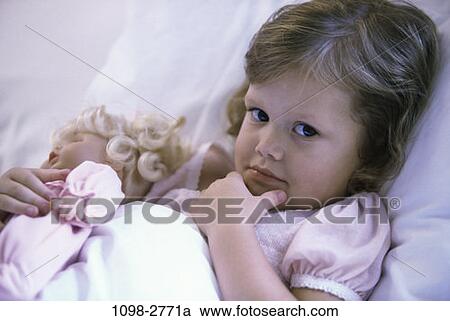 Stock Image - people, bed, toddler, doll, holding, girl. Fotosearch