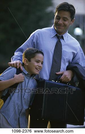 Stock Photograph - people, briefcase, talking, backpack, laughing, outdoors, carrying. Fotosearch