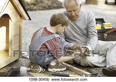 Stock Image - people, building, tools, outdoors, family, showing. Fotosearch