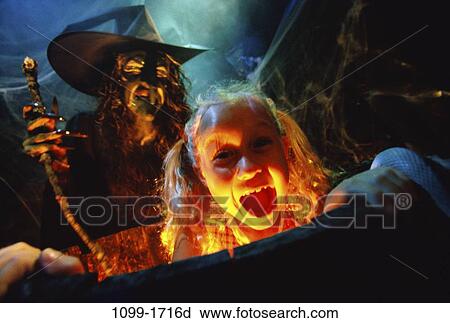 Stock Image - people, cooking, girl, Halloween, cauldron, witch, child. Fotosearch