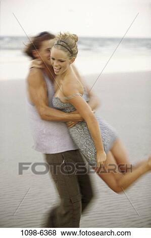 people, couple, beach, teens, clothed, spin View Large Photo Image Stock Photo - people, couple, beach, teens, clothed, spin. Fotosearch
