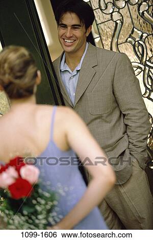 Stock Photograph - people, couple, door, flowers, outdoors, court, surprise. Fotosearch