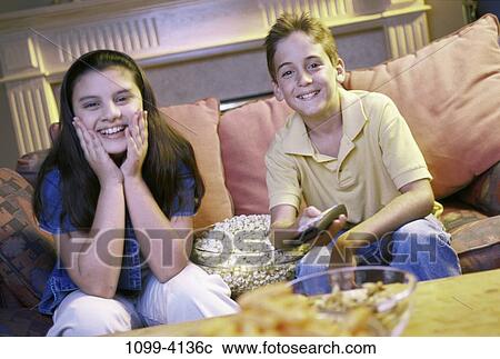 people, couple, entertainment, watching, amused, television View Large Photo Image Stock Image - people, couple, entertainment, watching, amused, television. Fotosearch