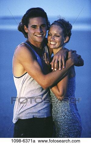 people, couple, evening, beach, hugging, embracing, embrace View Large Photo Image Stock Image - people, couple, evening, beach, hugging, embracing, embrace. Fotosearch