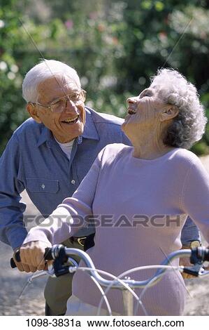 people, couple, eyeglasses, senior, bicycle, laughing, outdoors View Large Photo Image Stock Image - people, couple, eyeglasses, senior, bicycle, laughing, outdoors. Fotosearch