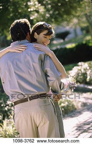 people, couple, flowers, outdoors, romantic, hugging, unity View Large Photo Image Stock Image - people, couple, flowers, outdoors, romantic, hugging, unity. Fotosearch