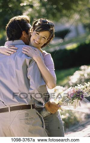 people, couple, flowers, outdoors, Middle-aged, hugging, surprise View Large Photo Image Stock Image - people, couple, flowers, outdoors, Middle-aged, hugging, surprise. Fotosearch