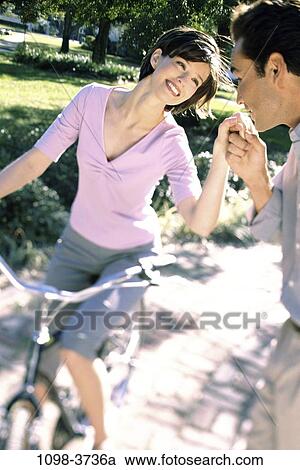 Stock Image - people, couple, Hispanic, bicycle, outdoors, romance. Fotosearch