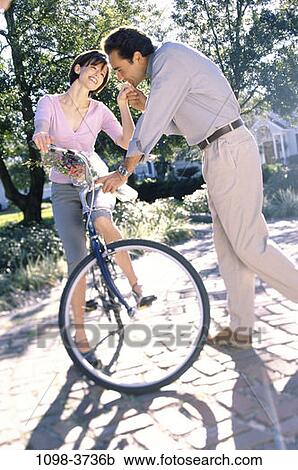 Stock Image - people, couple, Hispanic, bicycle, flowers, outdoors, romance. Fotosearch