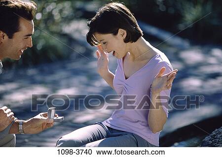 Stock Image - people, couple, outdoors, romantic, awe, joyous, commitment. Fotosearch