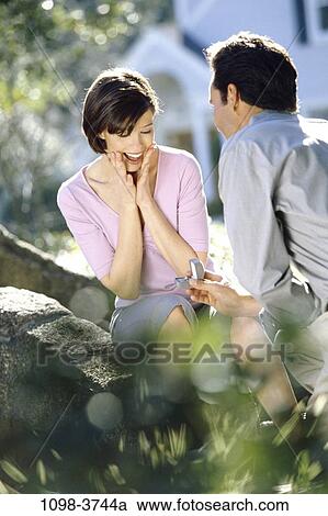 Stock Image - people, couple, outdoors, romantic, jewelry, commitment, unity. Fotosearch