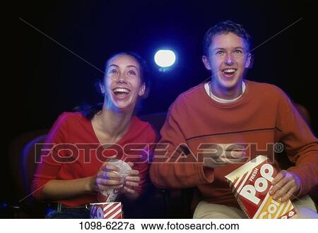 people, couple, theater, popcorn, watch, watching View Large Photo Image Stock Image - people, couple, theater, popcorn, watch, watching. Fotosearch