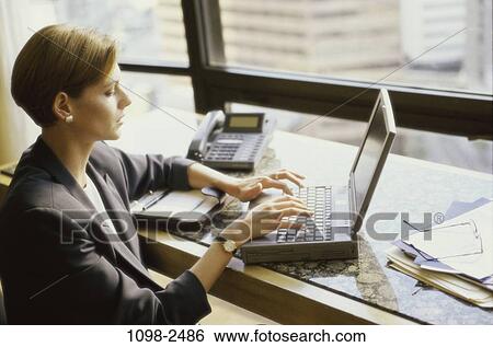 people, desk, computer, laptop, typing, business, brunette View Large Photo Image Stock Photograph - people, desk, computer, laptop, typing, business, brunette. Fotosearch