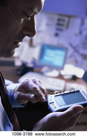 Stock Photo - people, desk, computer, Middle-aged, device, portable, businessman. Fotosearch