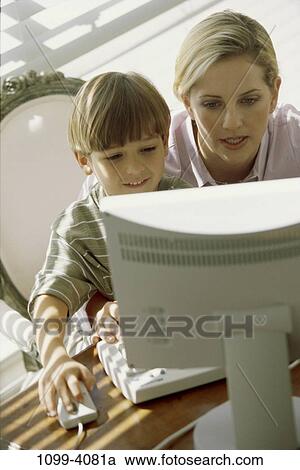 people, desk, table, mouse, mother, computer, family View Large Photo Image Stock Image - people, desk, table, mouse, mother, computer, family. Fotosearch