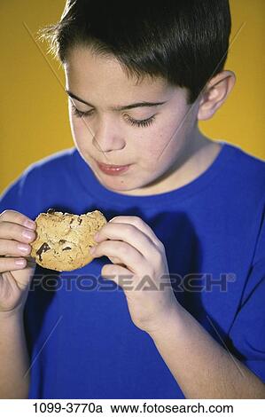 people, eating, chip, chocolate, holding, boy, looking View Large Photo Image Stock Image - people, eating, chip, chocolate, holding, boy, looking. Fotosearch