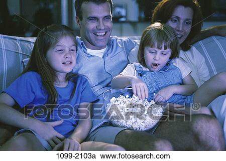 people, eating, sitting, popcorn, bowl, watch, couch View Large Photo Image Stock Image - people, eating, sitting, popcorn, bowl, watch, couch. Fotosearch