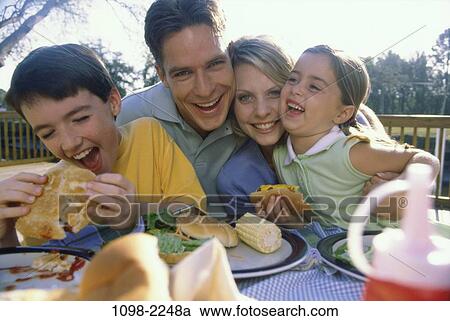 people, eating, smiling, picnic, laughing, outdoors, hugging View Large Photo Image Stock Image - people, eating, smiling, picnic, laughing, outdoors, hugging. Fotosearch