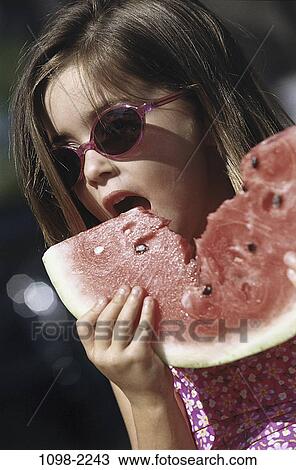 Stock Image - people, eating, watermelon, slice, fruit, sunglasses, holding. Fotosearch