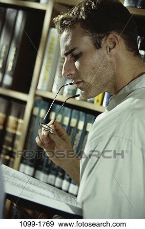 Stock Photo - people, eyeglasses, books, reading, book, studying. Fotosearch