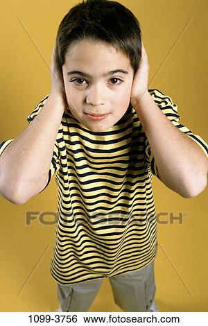 Stock Photograph - people, hands, ears, covering, boy, child, noise. Fotosearch