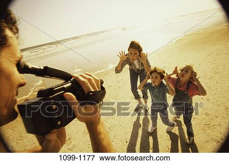 Stock Photo - people, hands, shadows, water, ocean, sun. Fotosearch