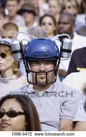 Stock Image - people, helmet, sports, crowd, beverage, spectator. Fotosearch