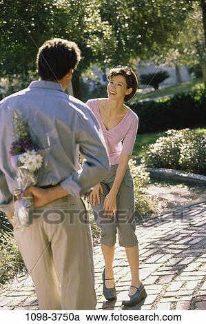 people, hiding, couple, flowers, outdoors, romantic, curious View Large Photo Image Stock Image - people, hiding, couple, flowers, outdoors, romantic, curious. Fotosearch