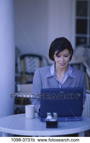 Stock Image - people, Hispanic, computer, laptop, cafe, business, outdoors. Fotosearch