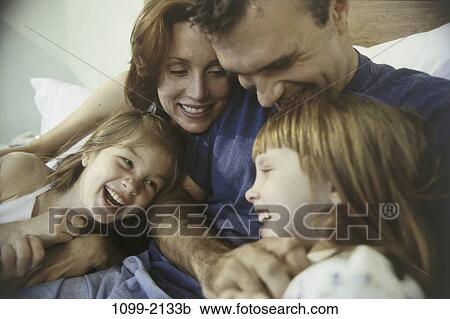 people, home, bed, family, daughters, parents, indoors View Large Photo Image Stock Image - people, home, bed, family, daughters, parents, indoors. Fotosearch