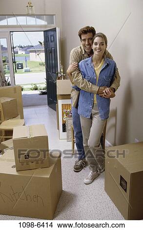 Picture - people, home, moving, couple, boxes, indoors. Fotosearch