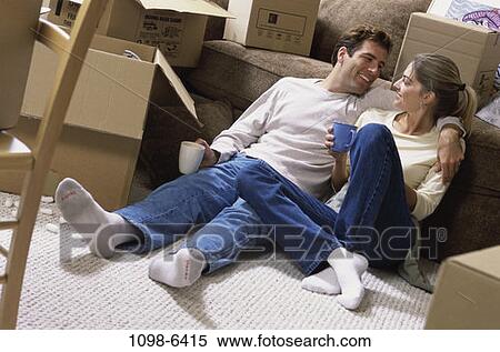 Stock Photography - people, home, moving, couple, sitting, floor. Fotosearch