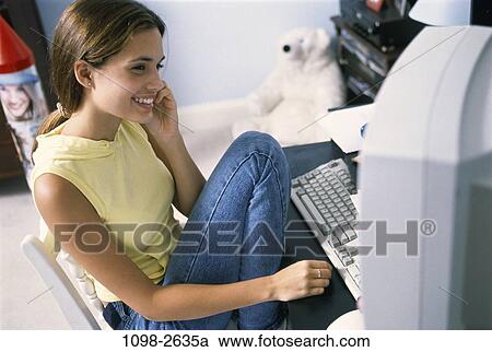 people, home, smiling, technology, sitting, computer View Large Photo Image Stock Image - people, home, smiling, technology, sitting, computer. Fotosearch