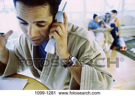 people, home, talking, Hispanic, watch, serious View Large Photo Image Stock Image - people, home, talking, Hispanic, watch, serious. Fotosearch