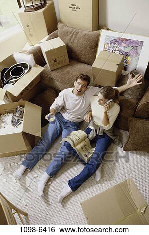 Stock Photograph - people, home, telephone, moving, talking, couple, conversation. Fotosearch