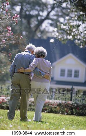 Picture - people, home, walking, couple, senior, outdoors, embracing. Fotosearch