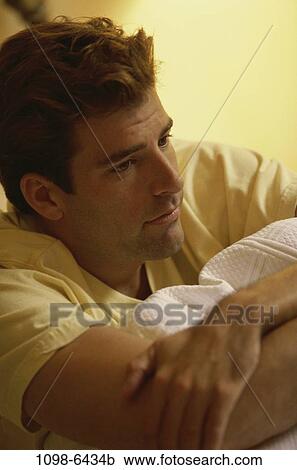 Stock Image - people, indoors, young adult, Young men indoors. Fotosearch