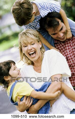 Stock Image - people, laughing, outdoors, carrying, joyous, family, piggyback. Fotosearch