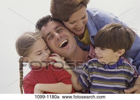 Stock Image - people, laughing, playful, outdoors, family, close. Fotosearch