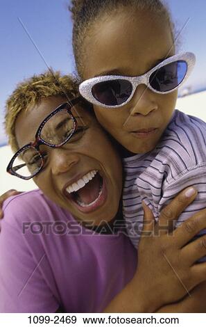 people, mother, beach, laughing, sunglasses, hugging, family View Large Photo Image Stock Photo - people, mother, beach, laughing, sunglasses, hugging, family. Fotosearch