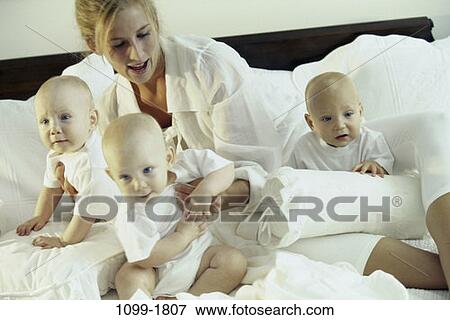 people, mother, bed, holding, family, babies View Large Photo Image Stock Photo - people, mother, bed, holding, family, babies. Fotosearch