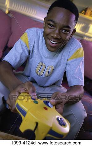 Stock Image - people, playing, boy, entertainment, television, controller, play. Fotosearch