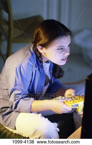 people, playing, concentrating, television, play, game, brunette View Large Photo Image Stock Photo - people, playing, concentrating, television, play, game, brunette. Fotosearch