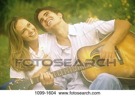people, playing, couple, music, guitar, flower, outdoors View Large Photo Image Picture - people, playing, couple, music, guitar, flower, outdoors. Fotosearch
