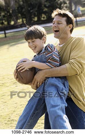 people, playing, football, catching, outdoors, family View Large Photo Image Stock Photograph - people, playing, football, catching, outdoors, family. Fotosearch