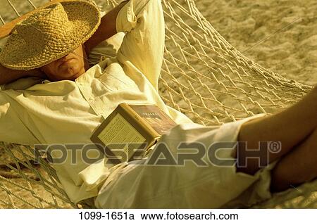 Stock Image - people, relaxation, hat, sleeping, senior, beach. Fotosearch