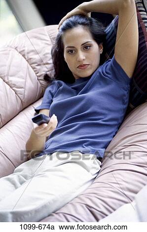 people, relaxation, woman, Hispanic, watch, couch, sofa View Large Photo Image Stock Image - people, relaxation, woman, Hispanic, watch, couch, sofa. Fotosearch
