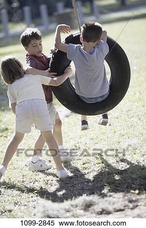 Stock Photography - people, rope, playing, swinging, swing, outdoors, friends. Fotosearch